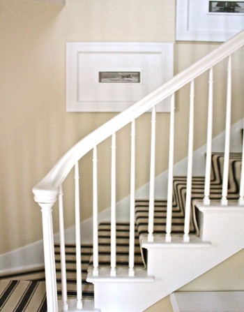 bone white painted wall and a white carpeted staircase