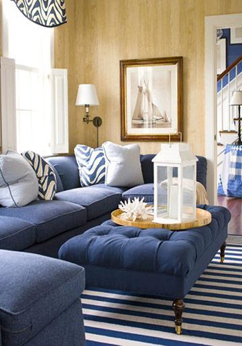 blue themed living area with blue upholstered sofas