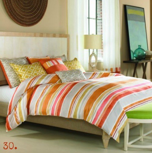 bed with orange, yellow and gray bedding