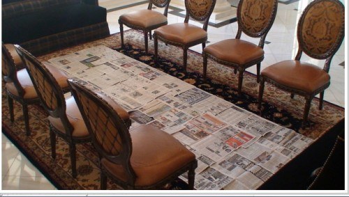 dining chairs and newspapers on the floor