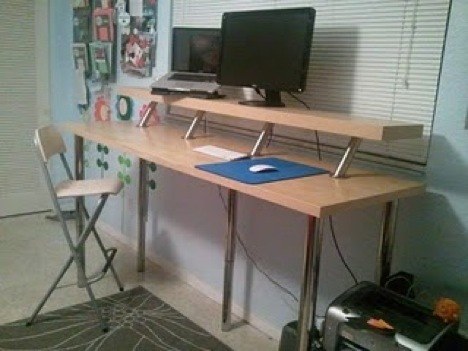sit stand desk setup in a room