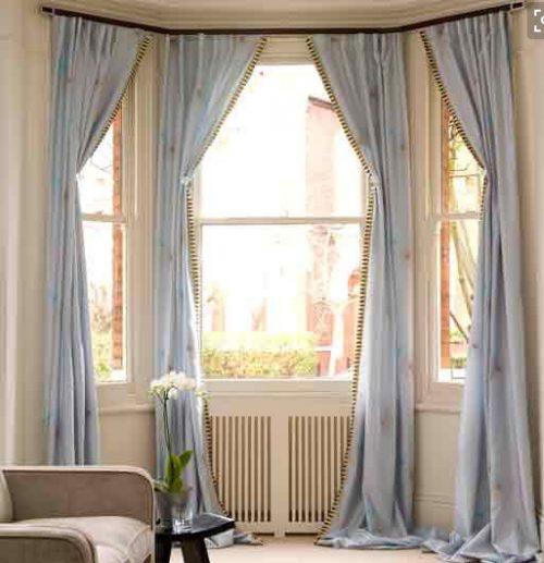large windows with light blue long curtains