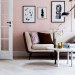beautiful pink living room with gallery art on wall