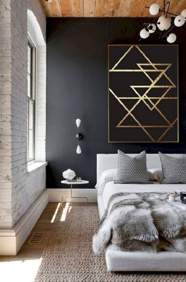 black and white bedroom with wall art above the bed