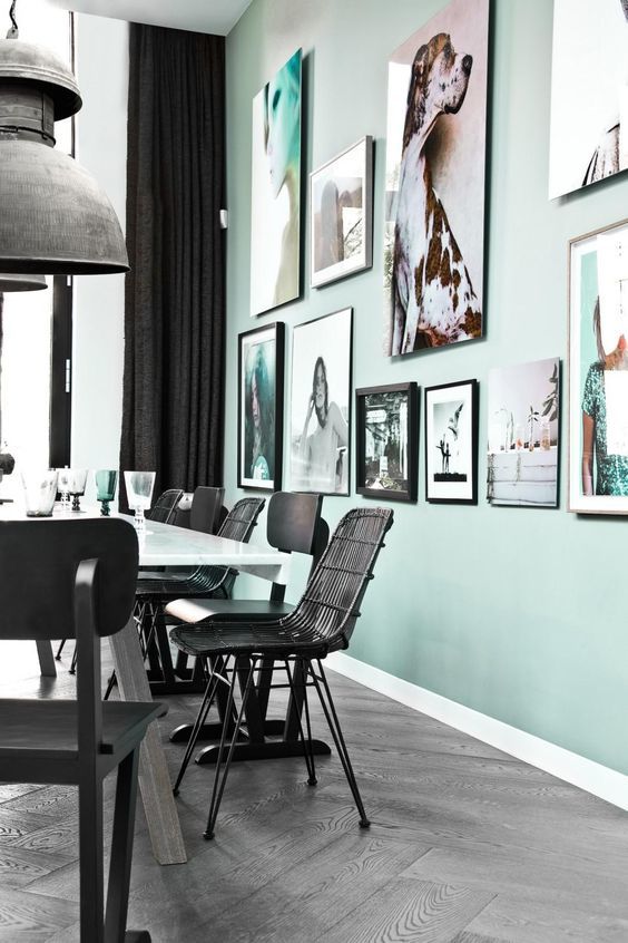 mint and black dining room with large wall art gallery