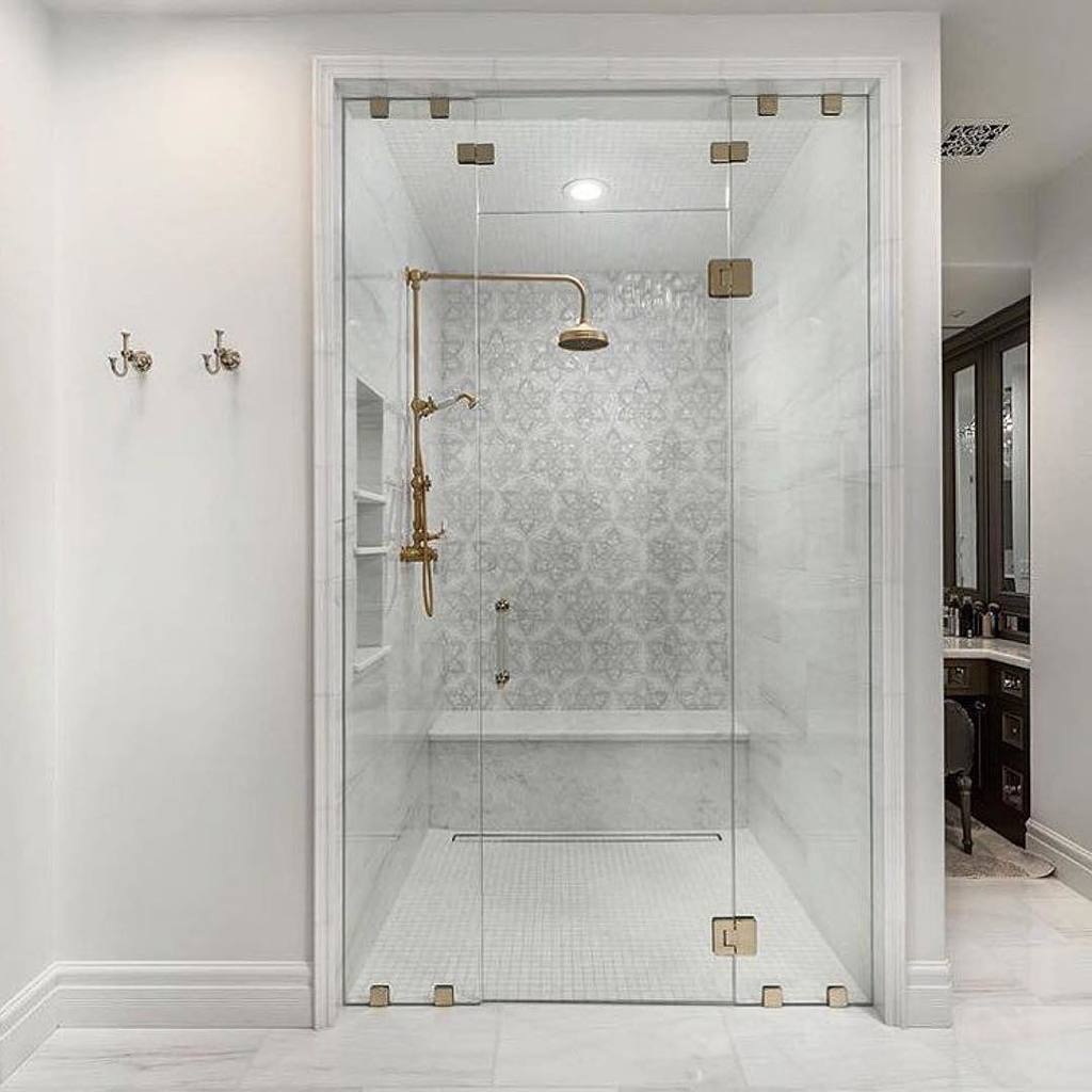elegant bathroom design with glass door and gold fixtures