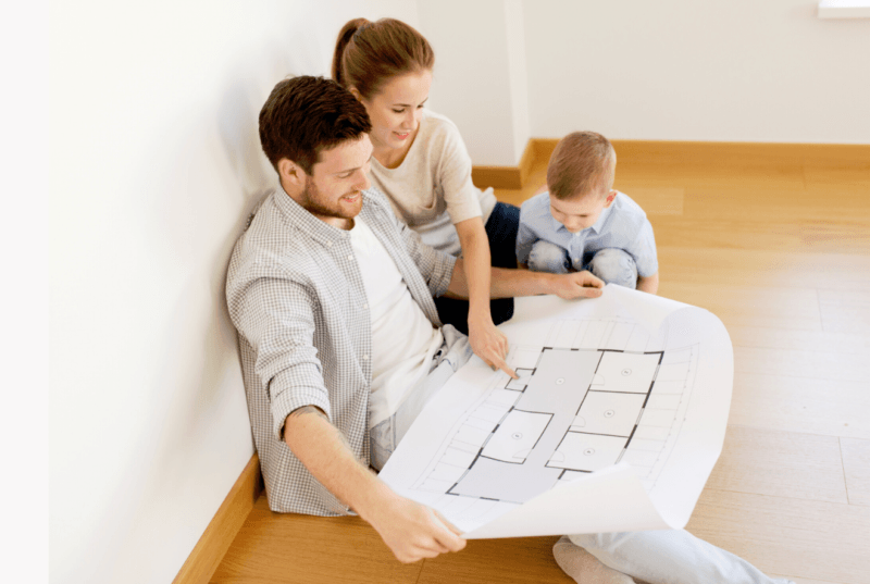 a family looking at a floor plan 