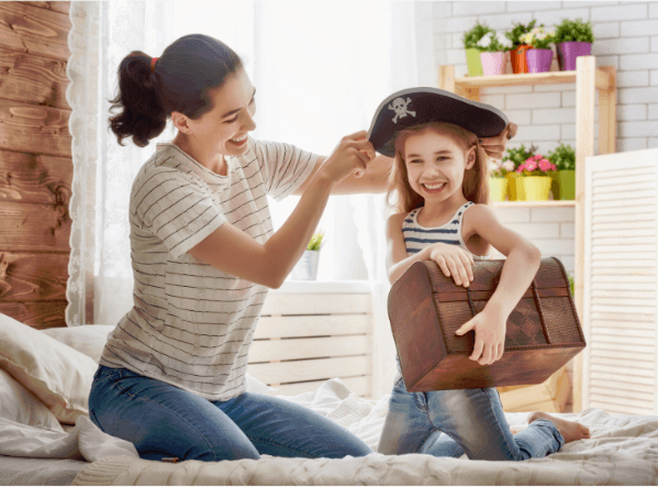 a mother is trying a hat to a girl 