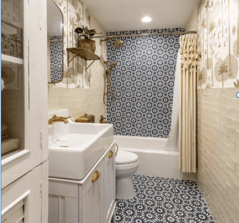 blue geometric tile in the shower, beige tile in the bathroom 