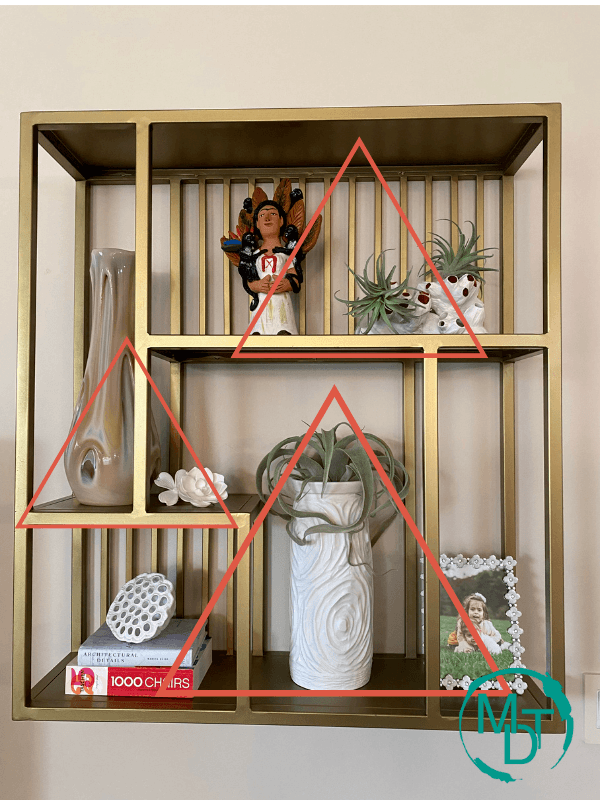 shelf decorating with objects showing triangle rule 